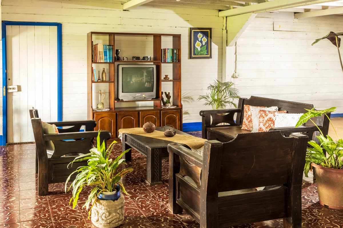 Family living room with antique wooden furniture, bookshelf, and vintage TV
