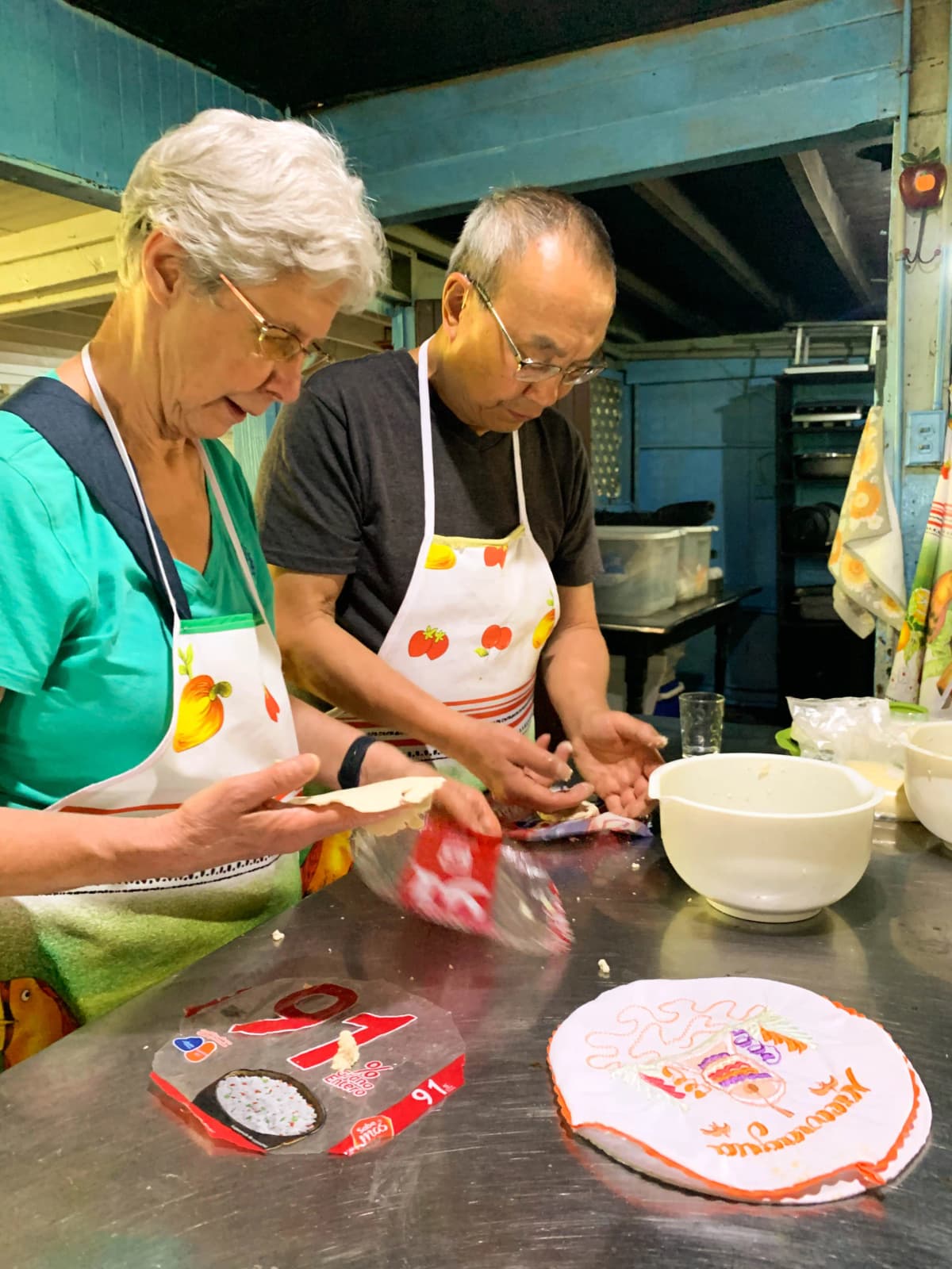 Senior couple making handmade corn tortillas during the cooking class