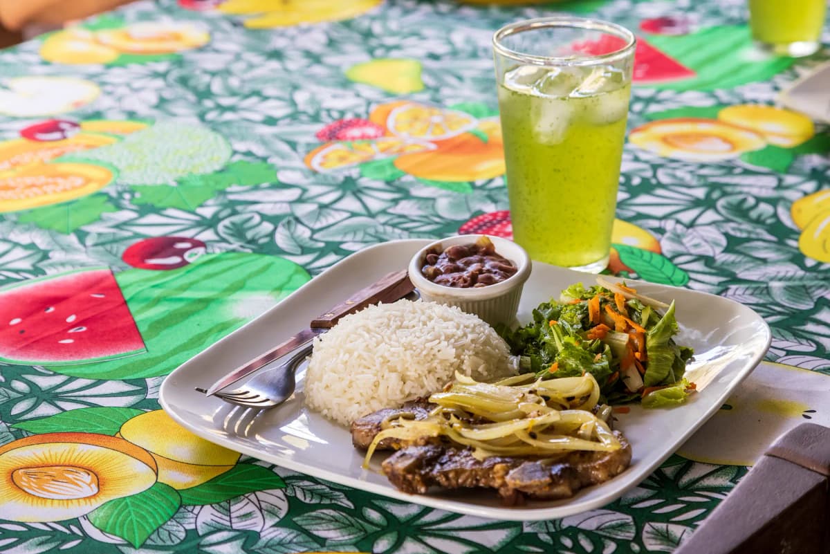 Traditional Costa Rican casado served with a fresh natural fruit drink