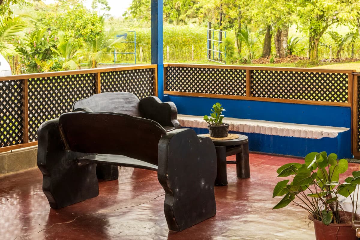 Hand-carved rustic wooden benches in the veranda of La Casona