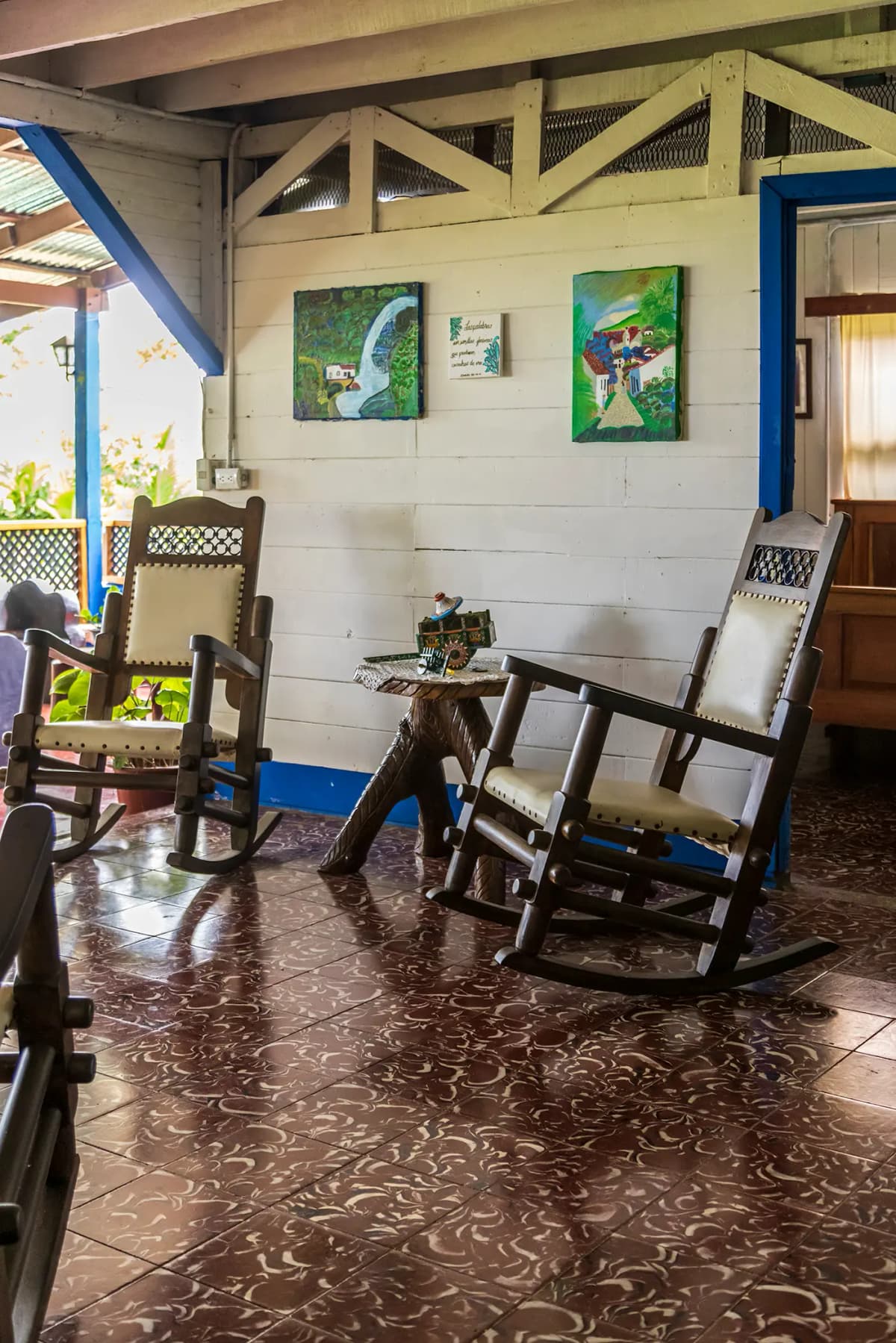 Traditional wooden and leather rocking chairs with miniature Costa Rican oxcart