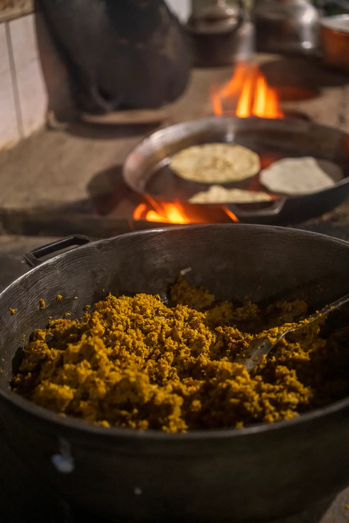 Freshly prepared handmade picadillo in a rustic pot over the wood-fired stove