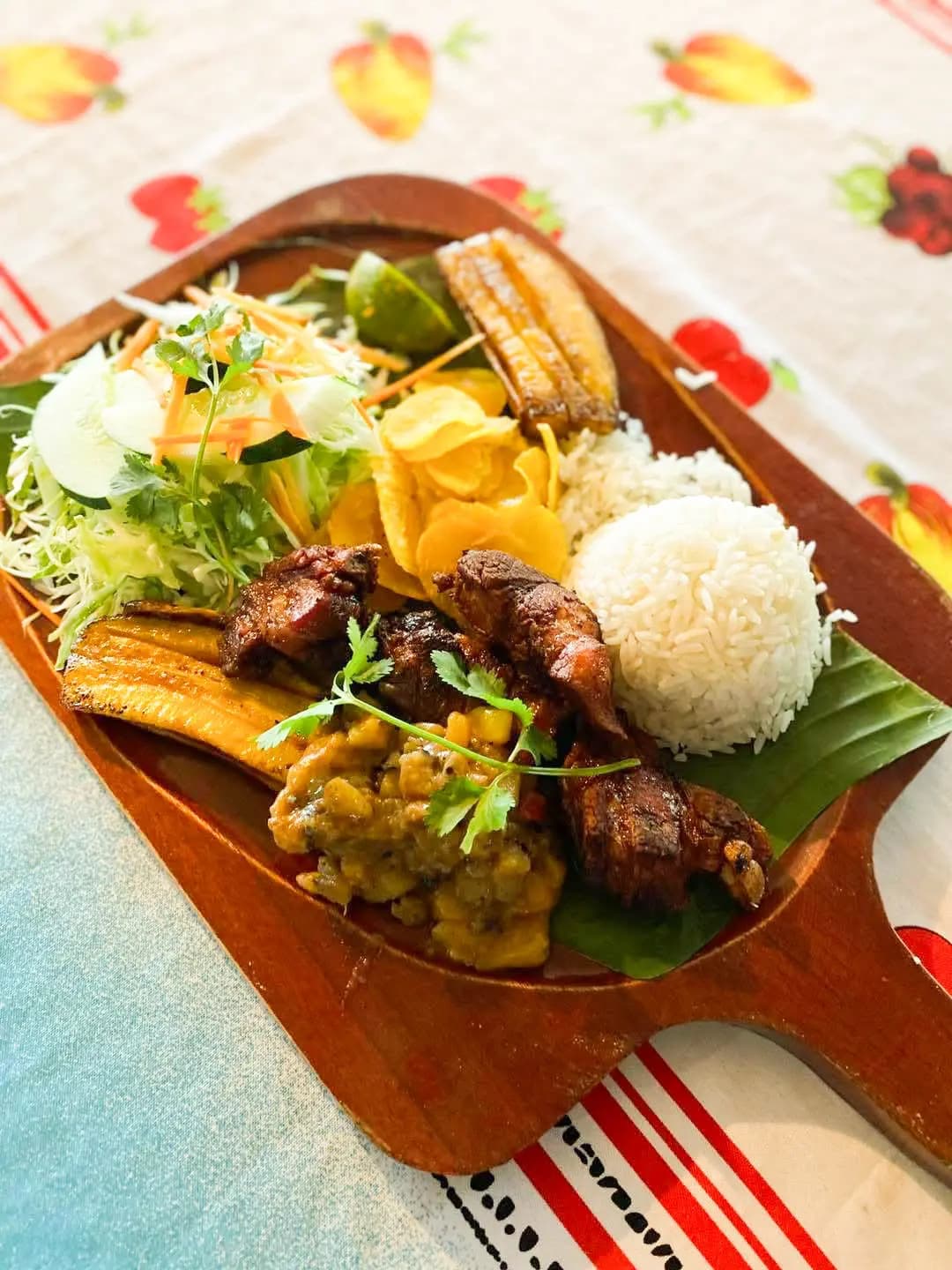 Wooden tray with a hearty, freshly prepared traditional Costa Rican casado